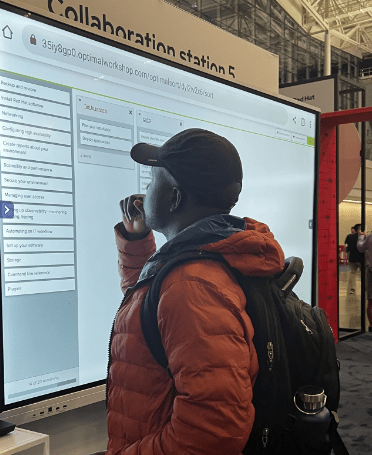 man looking at large screen with a list of choices for a Red Hat software product